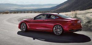 A man driving a red 2020 INFINITI Q60. | INFINITI dealer in Ellisville, MO